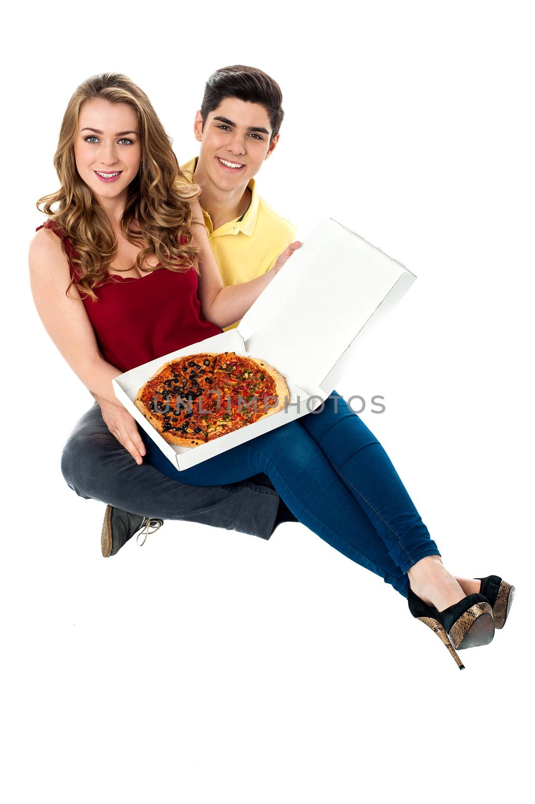 Young couple showing medium sized pizza