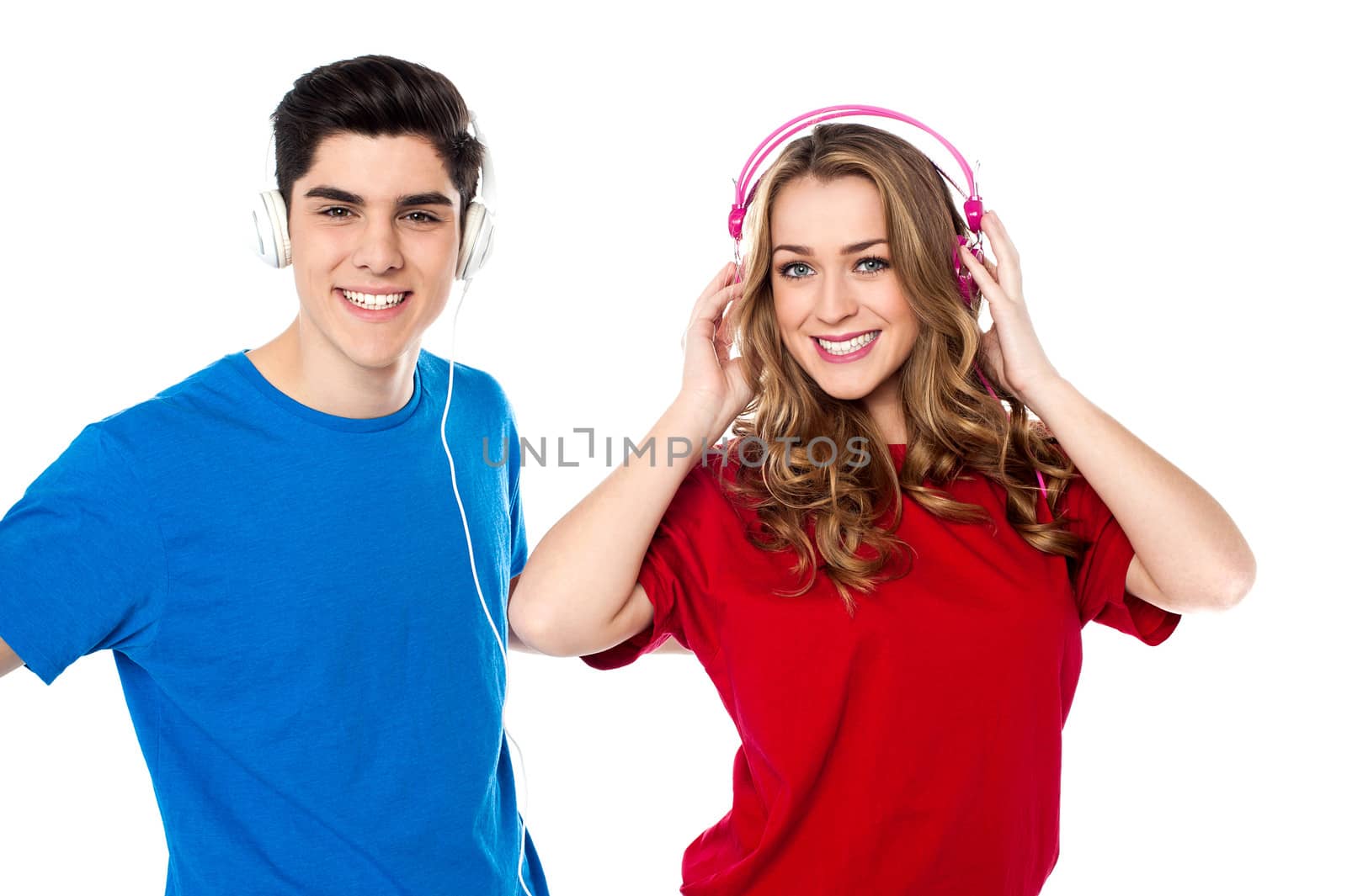 Adorable young couple enjoying music by stockyimages