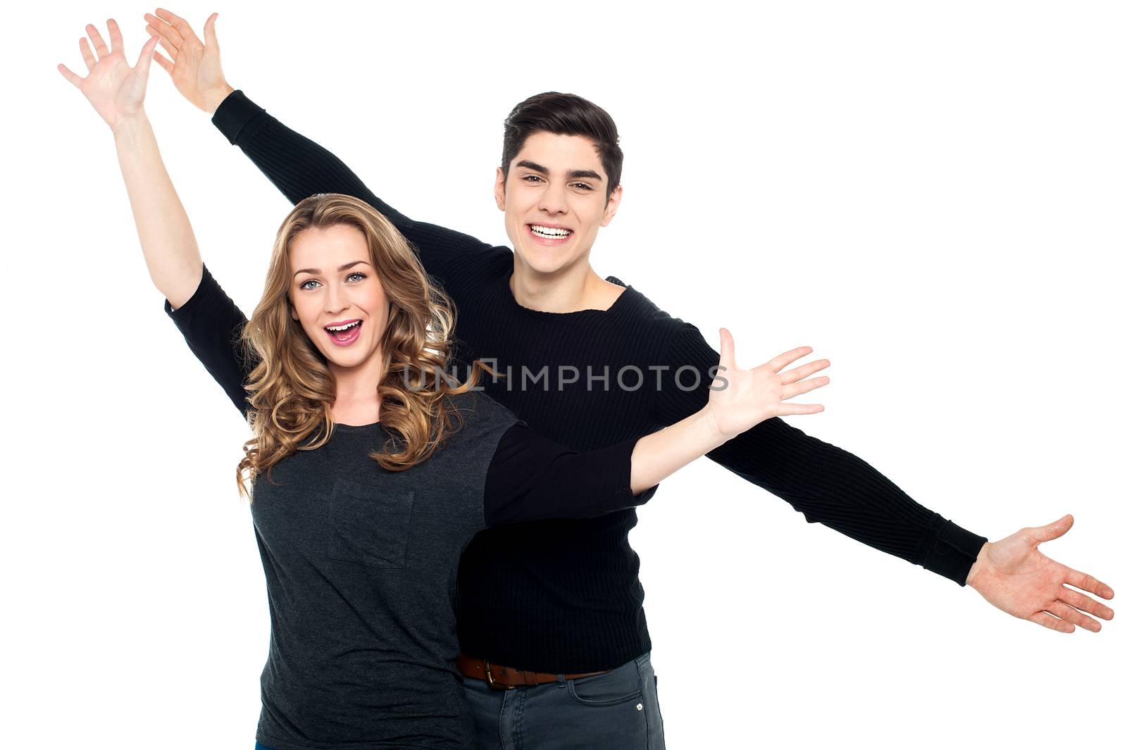 Couple having fun, arms outstretched.