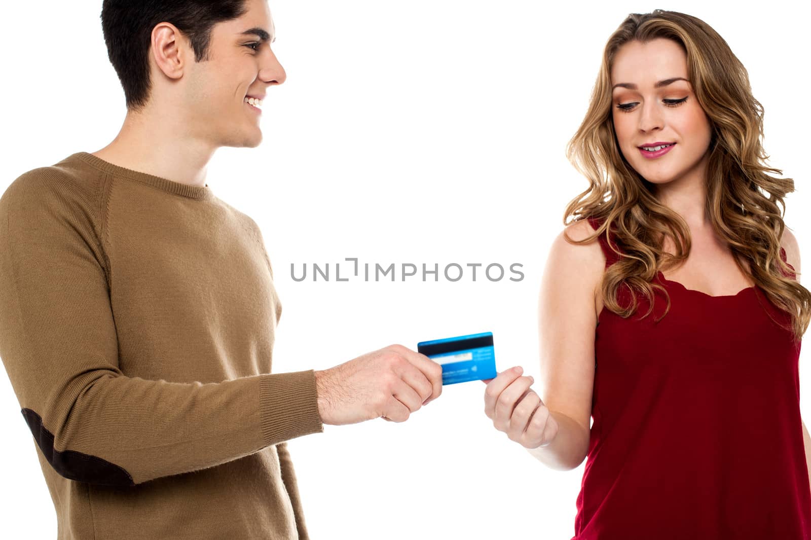 Young guy giving credit card to his girlfriend