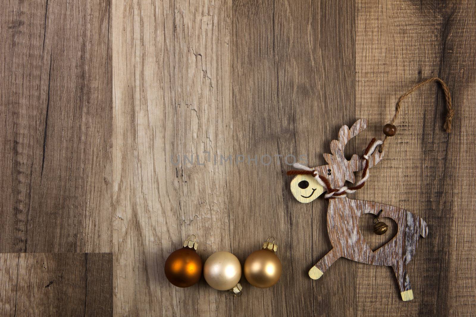 christmas baubles brown, moose on wooden background 