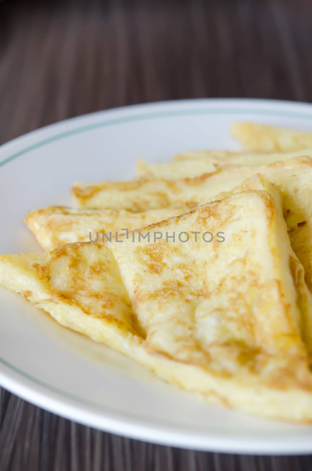 close up slices of french toast on a white dish