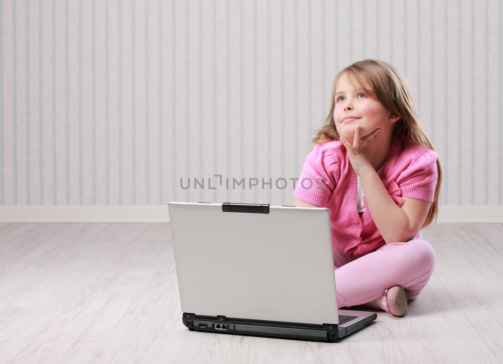 Cute little girl with laptop by stokkete