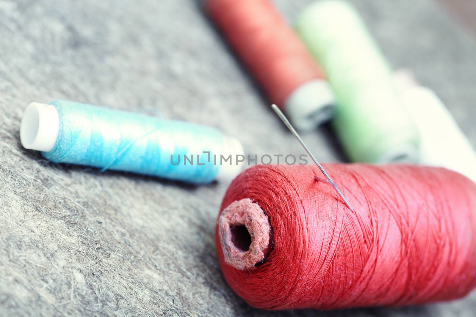 Sewing spools on a woolen fiber. Close-up photo