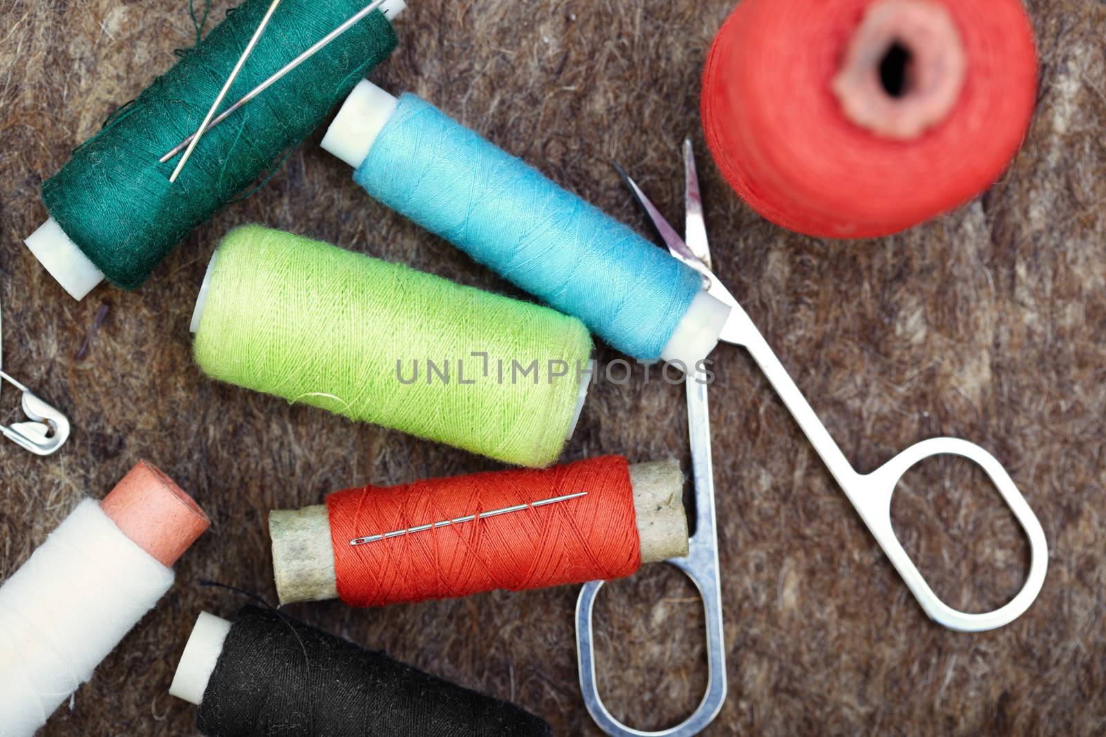 Sewing tools on a woolen fiber. Close-up color photo