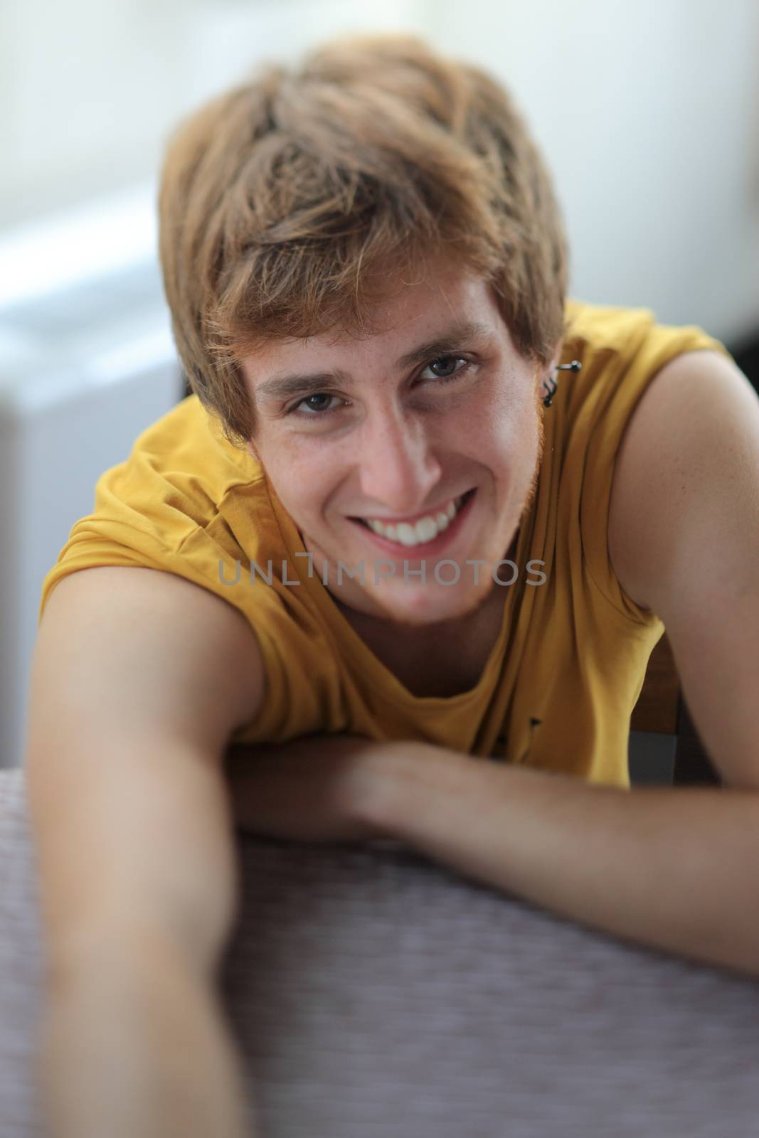 Close-up of a young man smiling.Tilt shift lens
