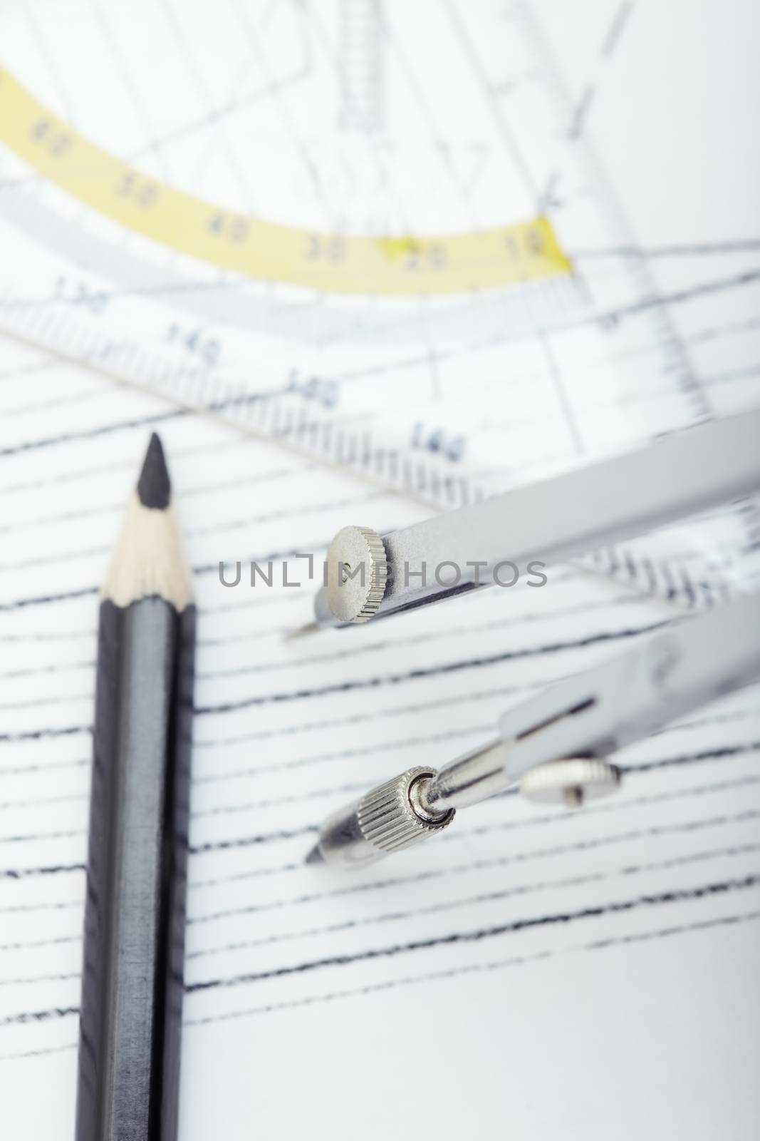 Scheme with drawing tools. Extremely close-up photo. Focus on the compasses