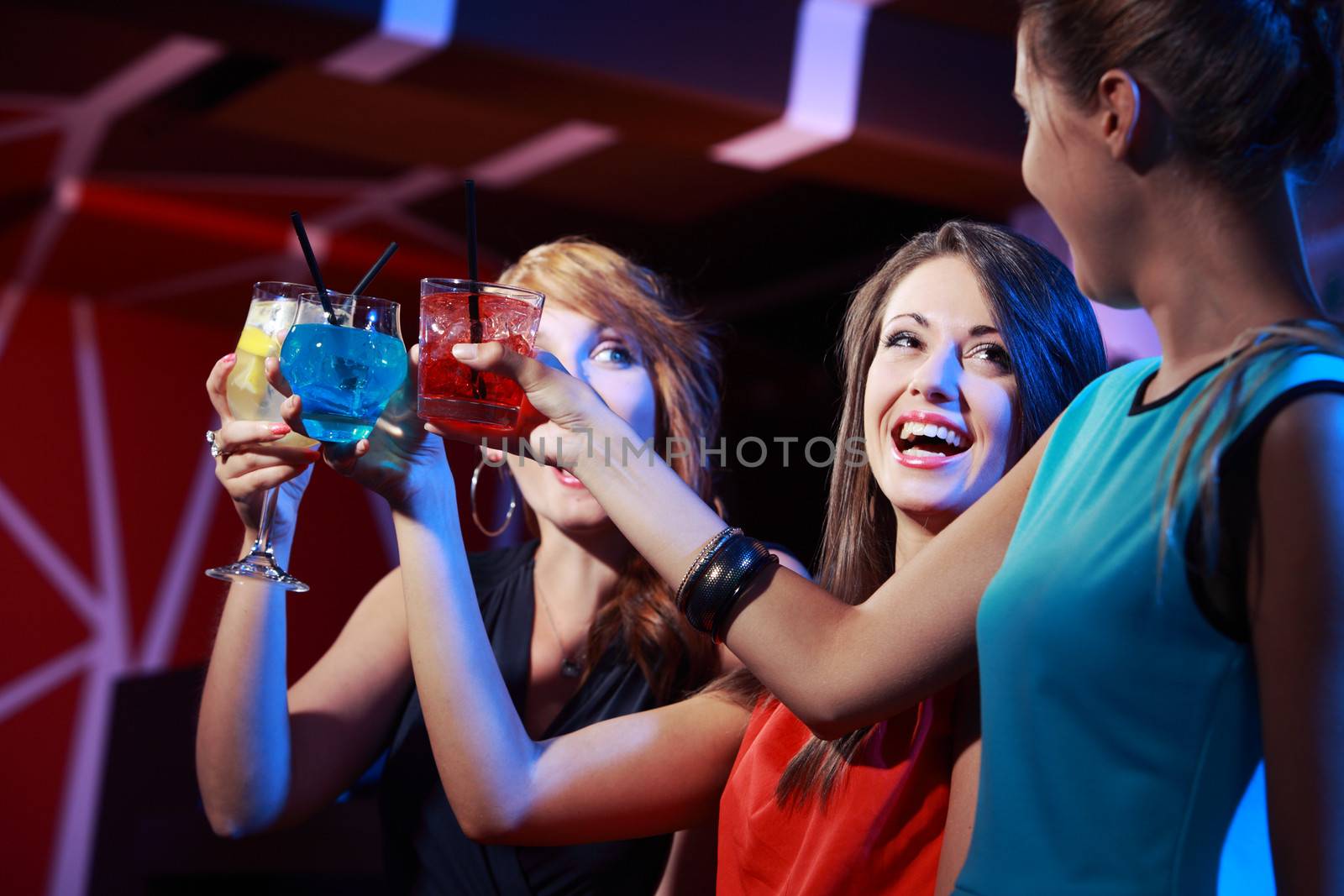 Portrait of joyful friends toasting at party 