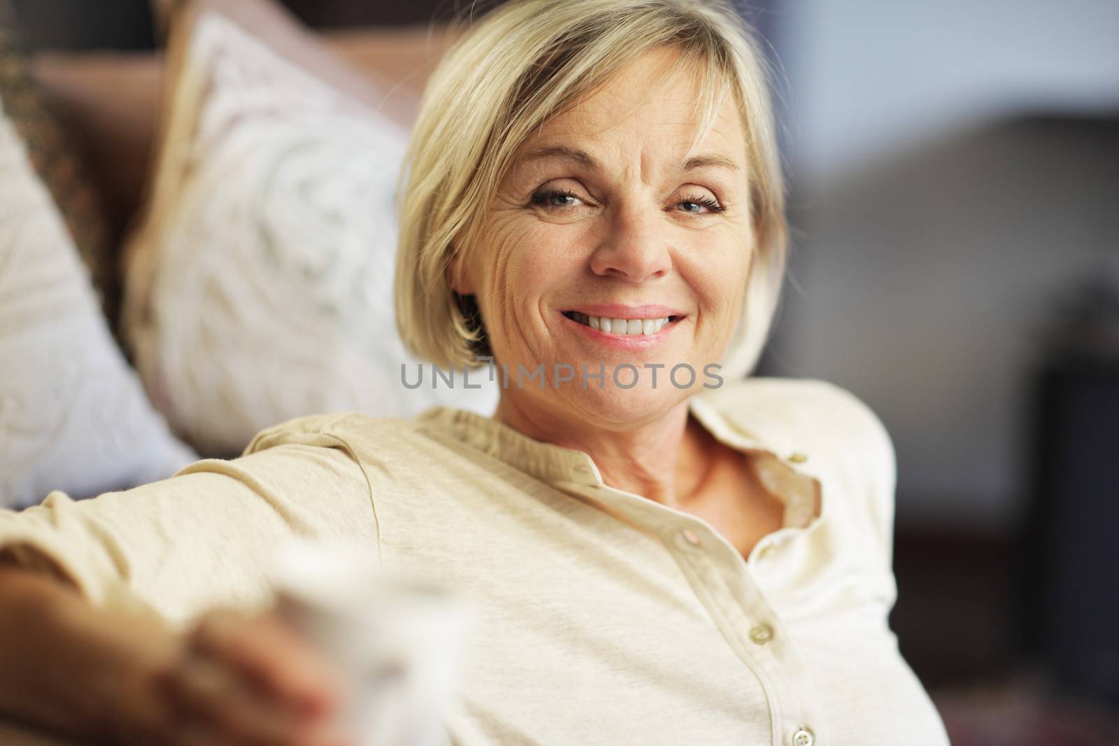 A smiling senior woman enjoying a cup of coffee 