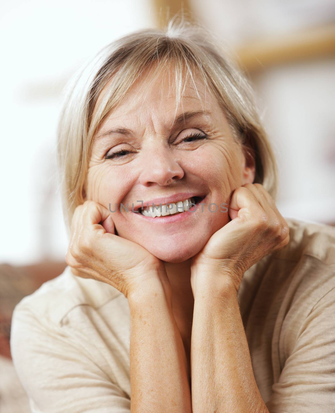 Portrait of a smiling senior woman sitting on couch