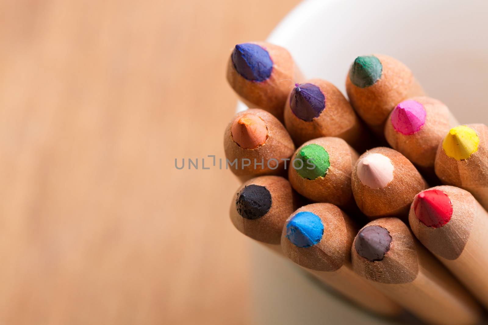 colored pencils with brown blurred background