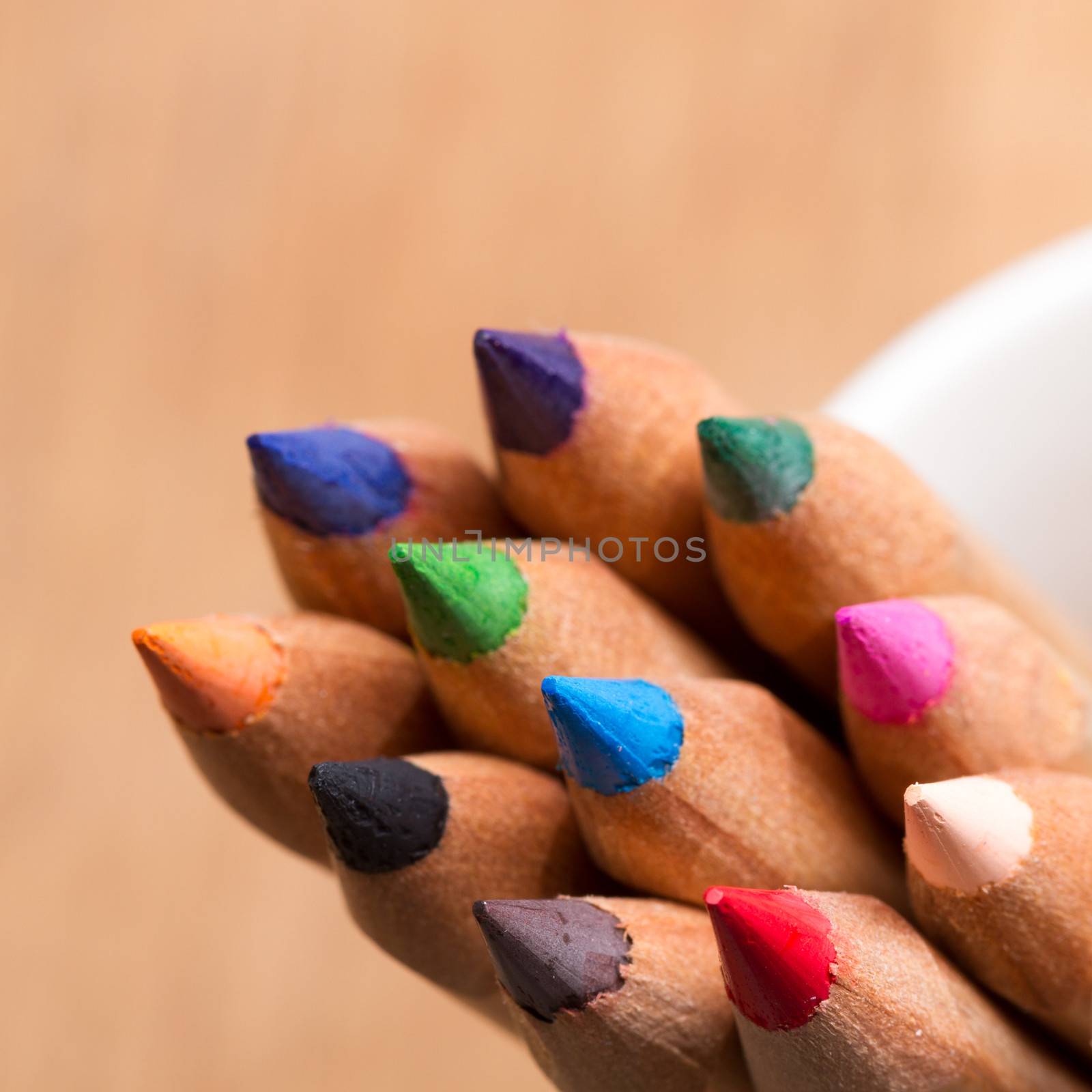 colored pencils with brown blurred background