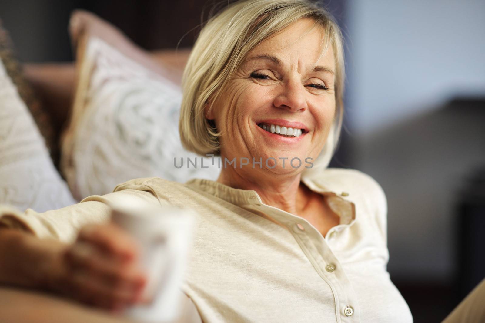 A pretty senior woman enjoying a cup of coffee 