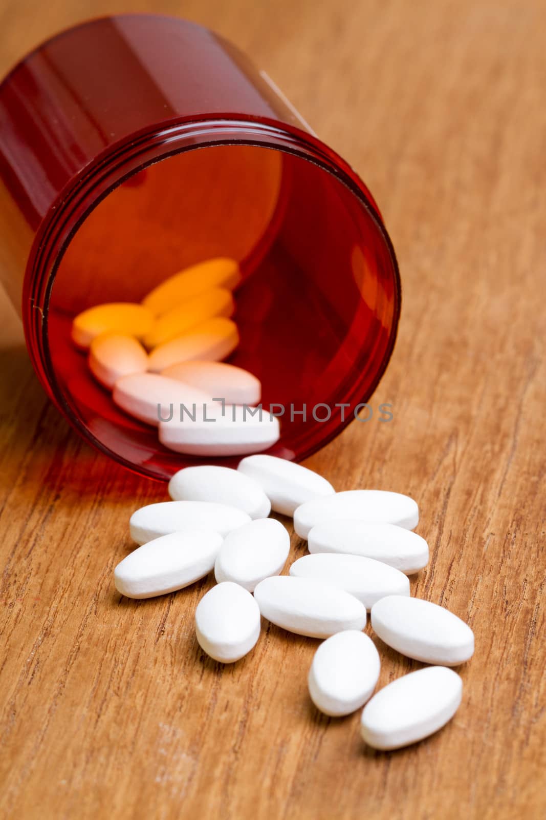 white pill with bottle on wooden plate