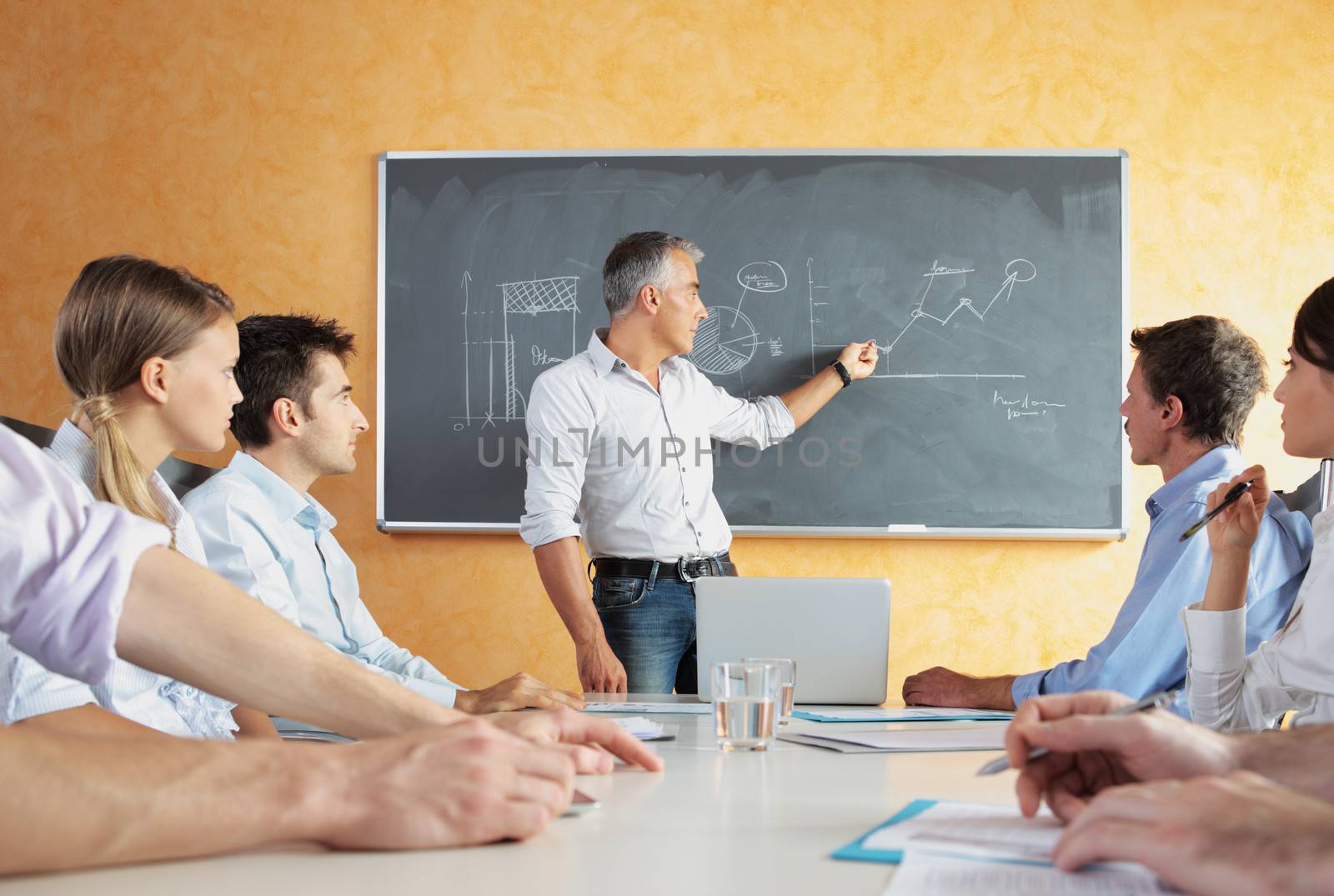 A group of businesspeople sitting in a seminar 