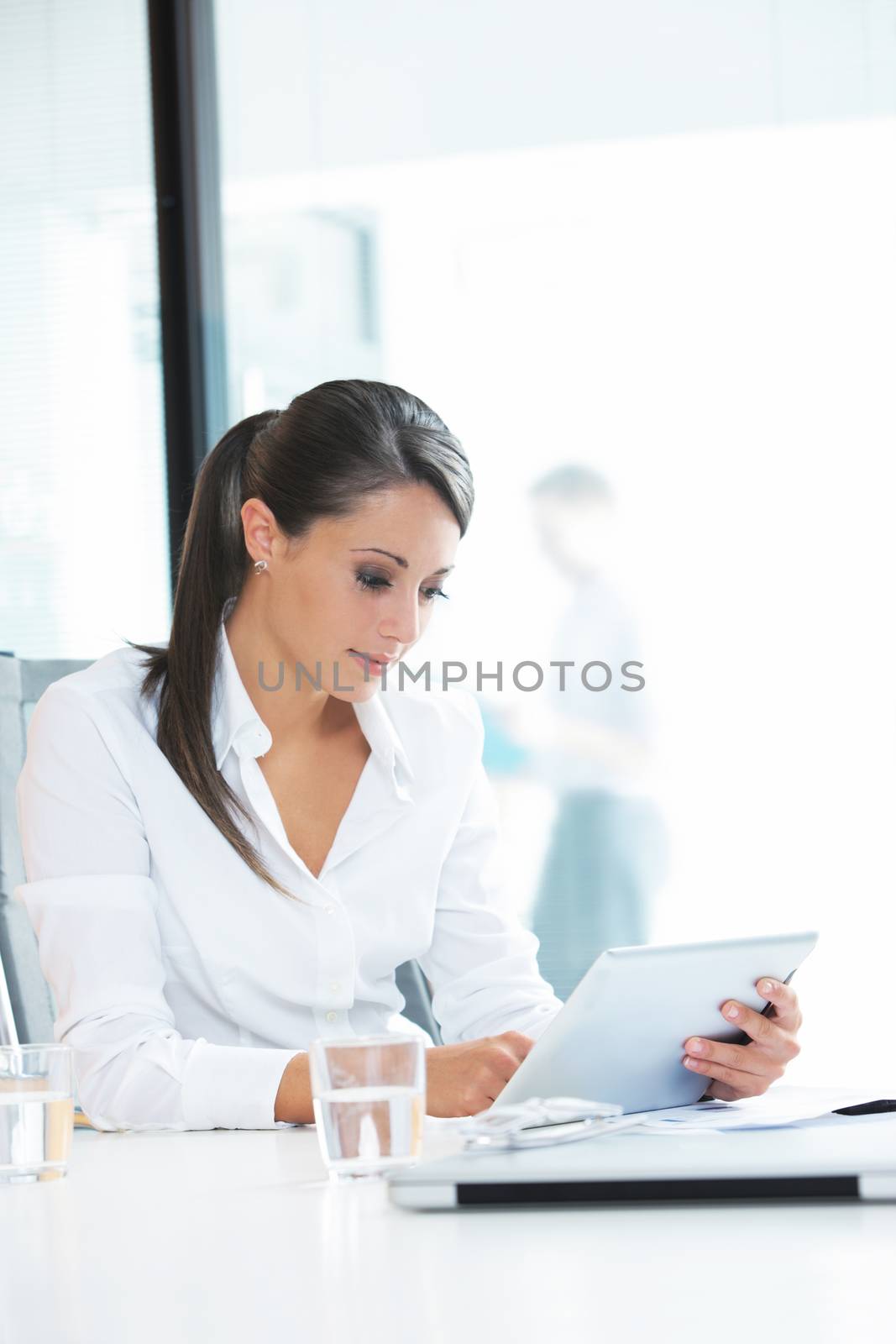 Young businesswoman using a digital tablet in office