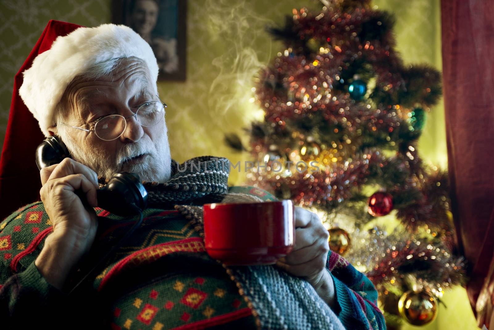 Pictures of Santa Claus relaxing at home and talking on phone