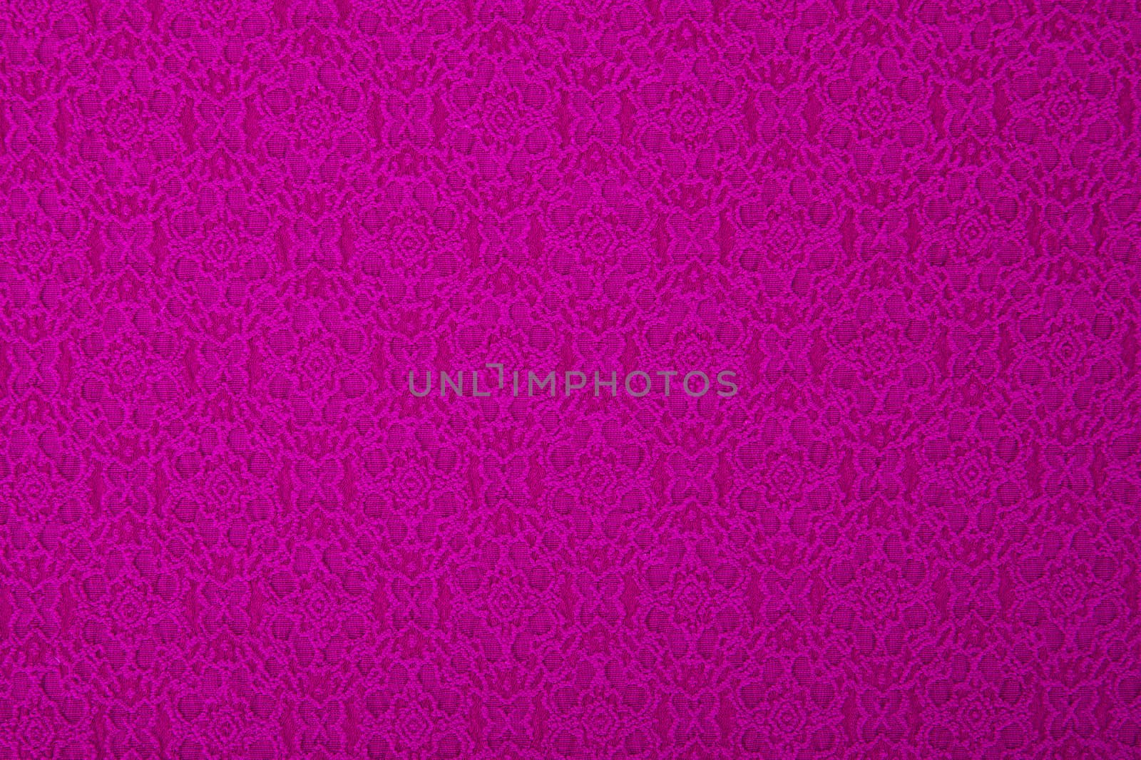 Pink/purple fabric with flowers, a textile background.