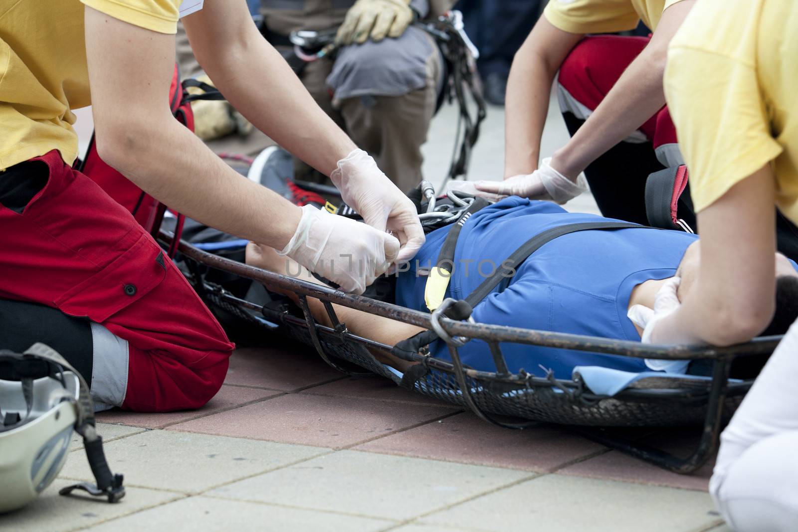 Paramedics putting a bandage on an injured hand