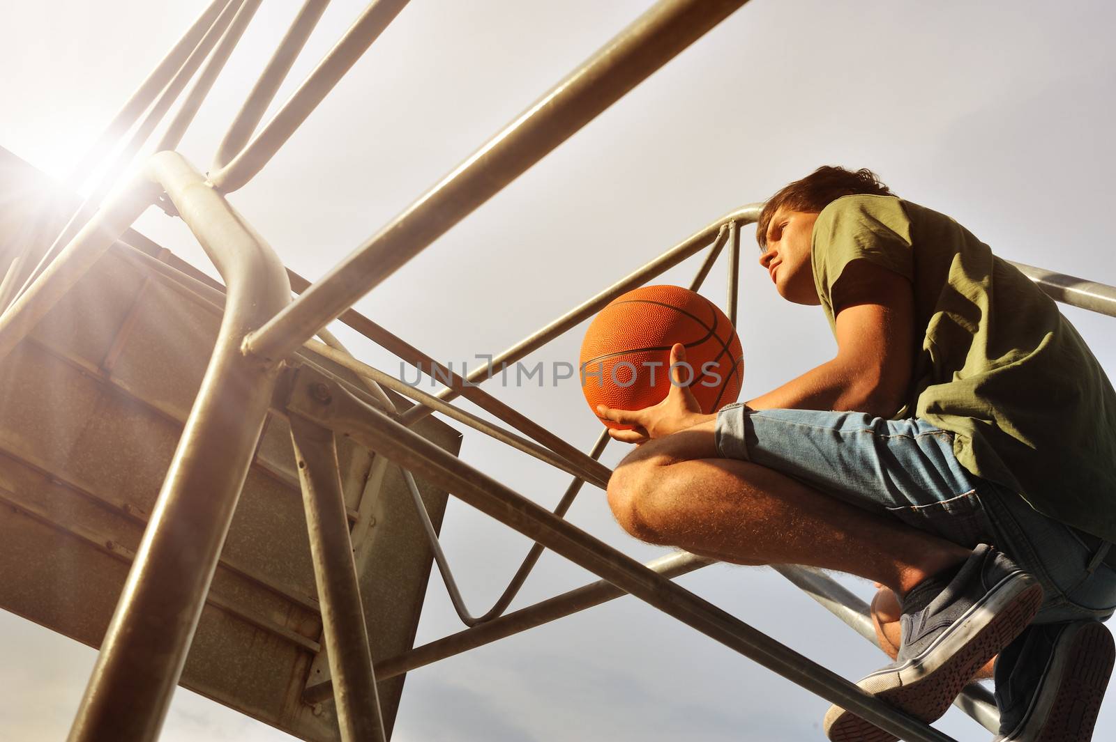 Boy with a basketball waiting his friends for a match