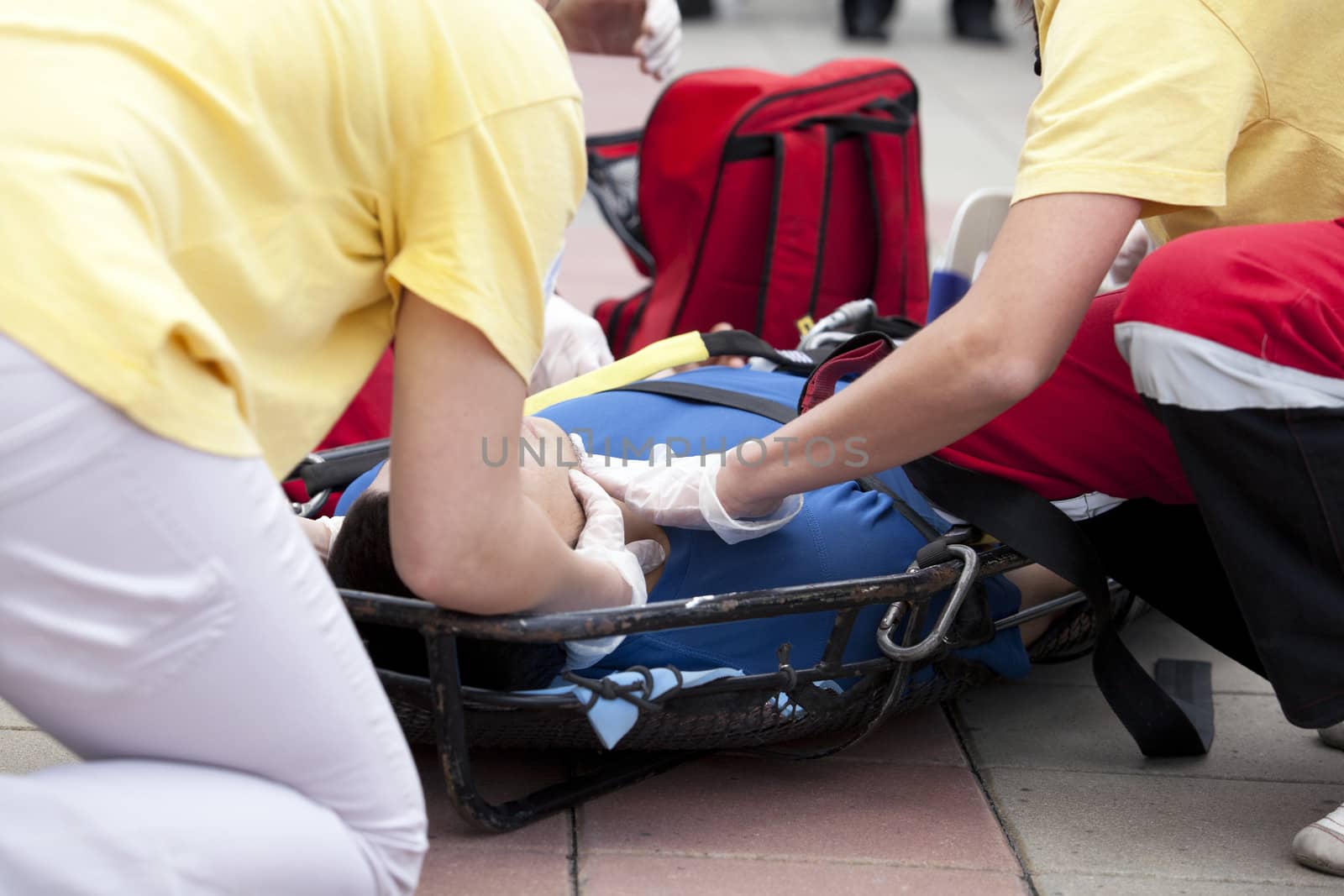 Paramedics putting a bandage on an injured hand