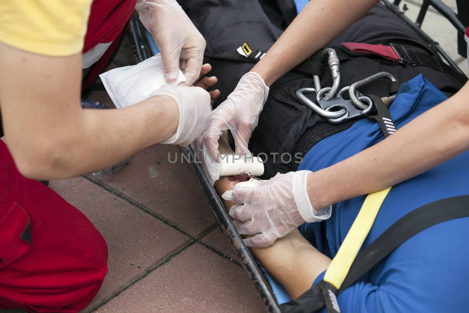 Paramedics putting a bandage on an injured hand