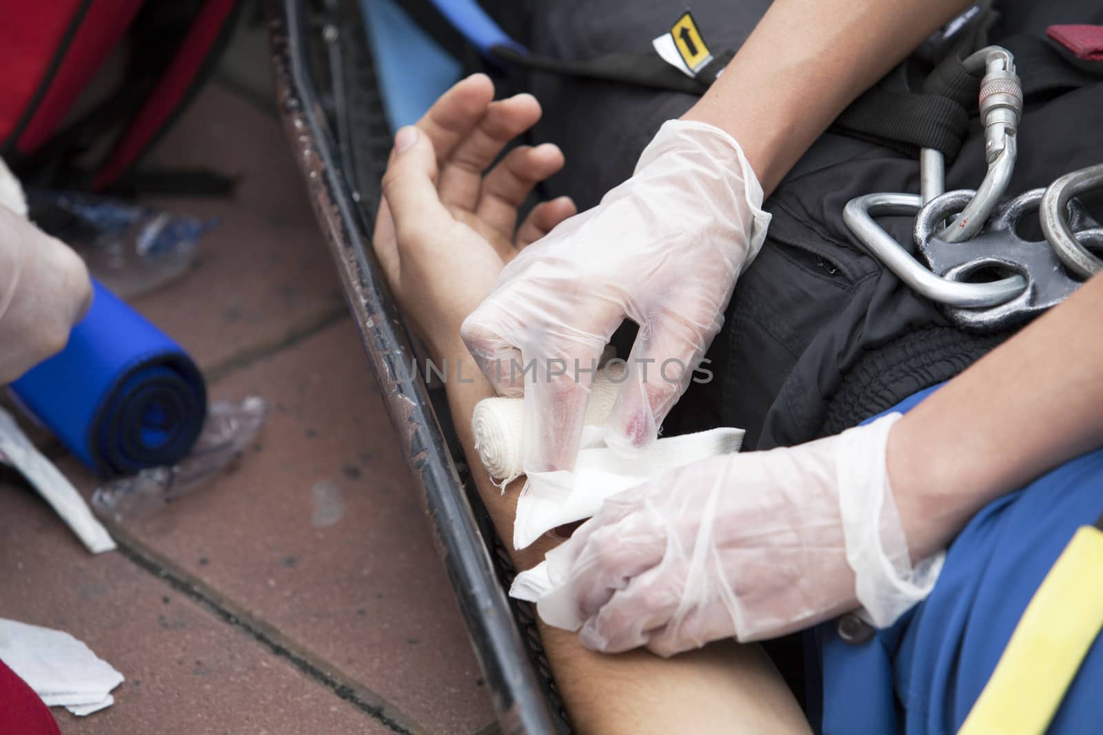 Paramedics putting a bandage on an injured hand