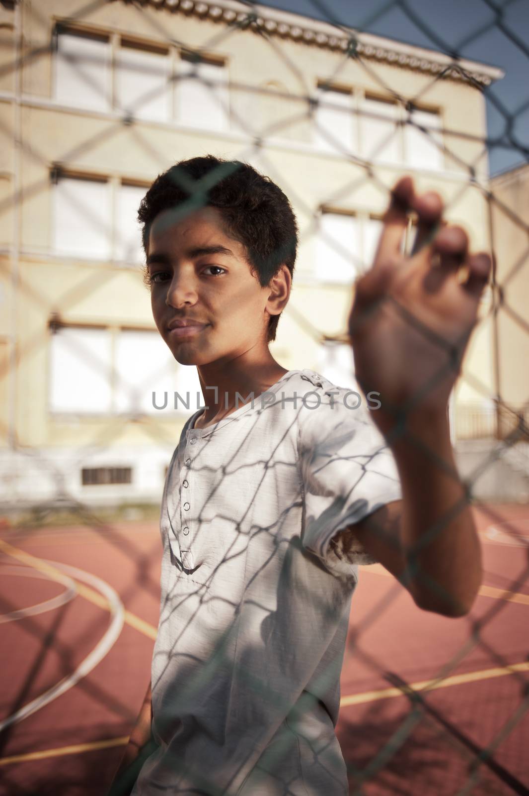 Portrait of young afro-american boy in a basketball court