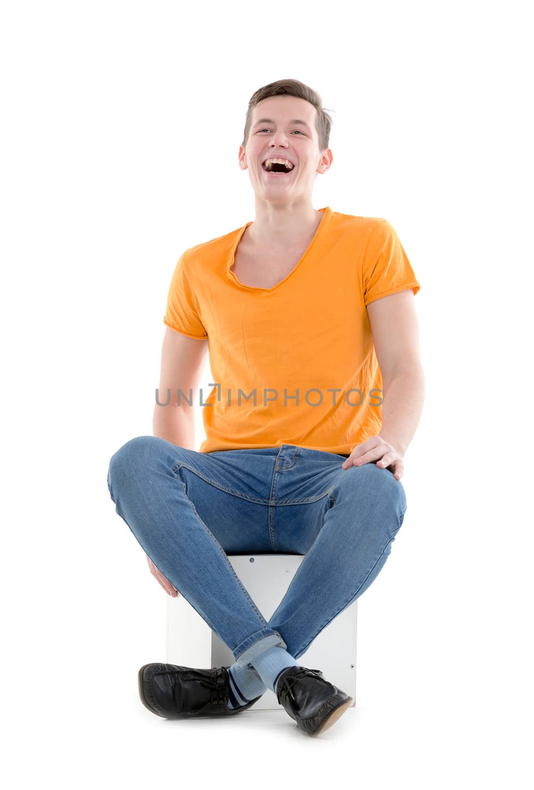 Young man laughing out loud, on white background by Discovod