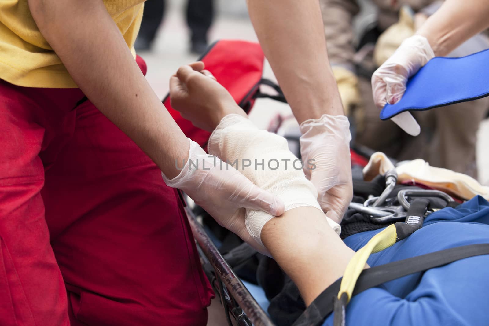 Paramedics putting a bandage on an injured hand