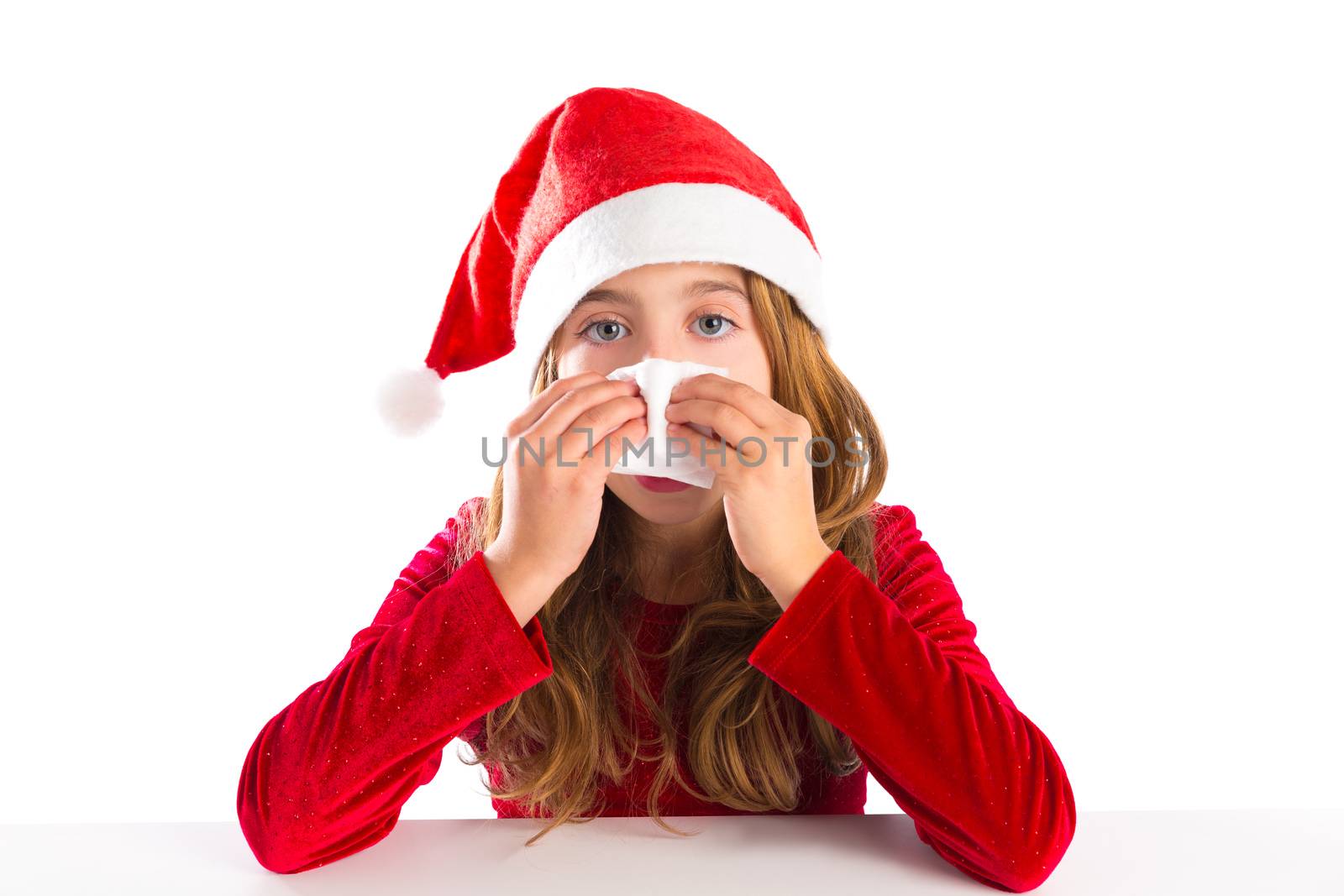 Christmas Santa kid girl blowing her nose in a winter cold isolated on white background