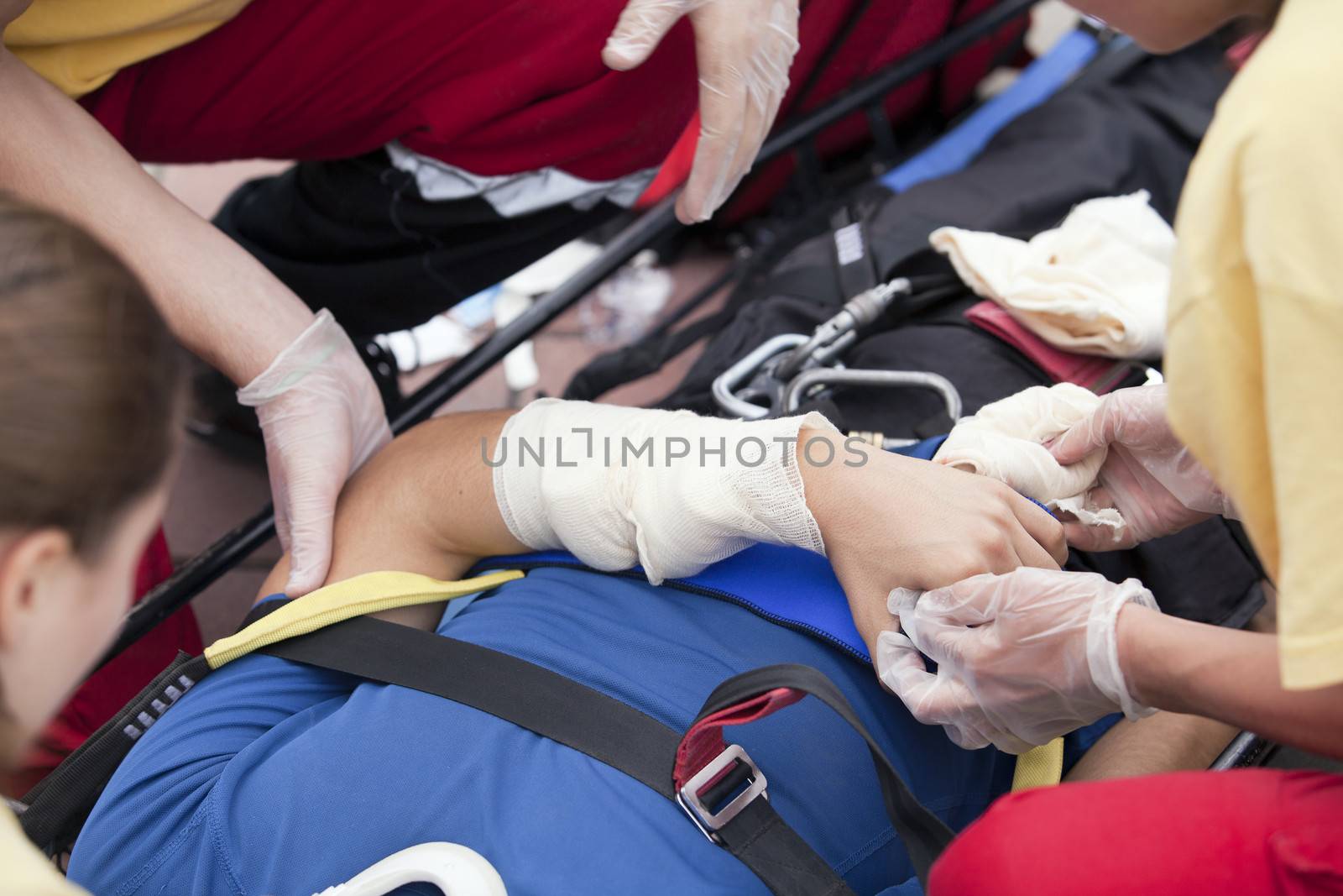 Paramedics putting a bandage on an injured hand