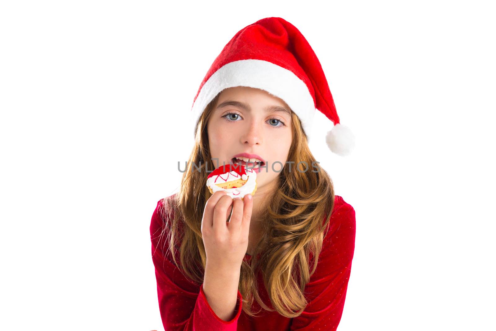 Christmas kid girl eating Xmas Santa cookie by lunamarina