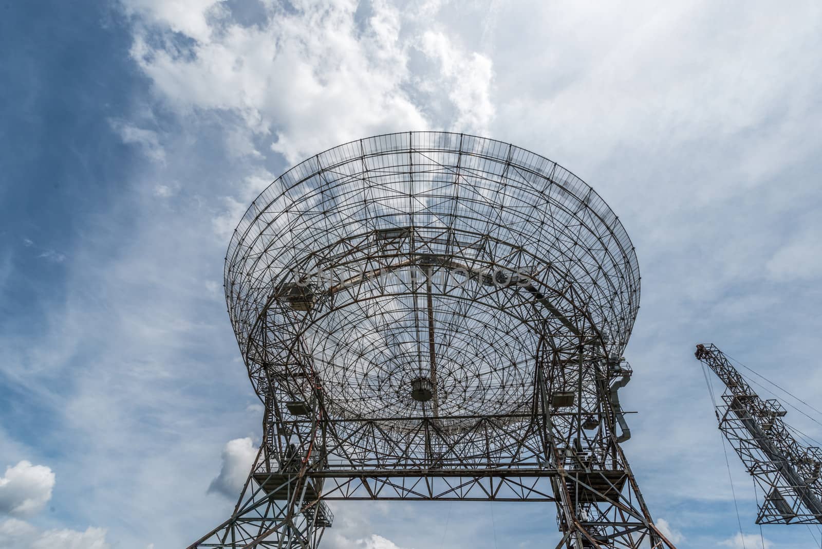 Base of a large astronomy radar with sky as background 