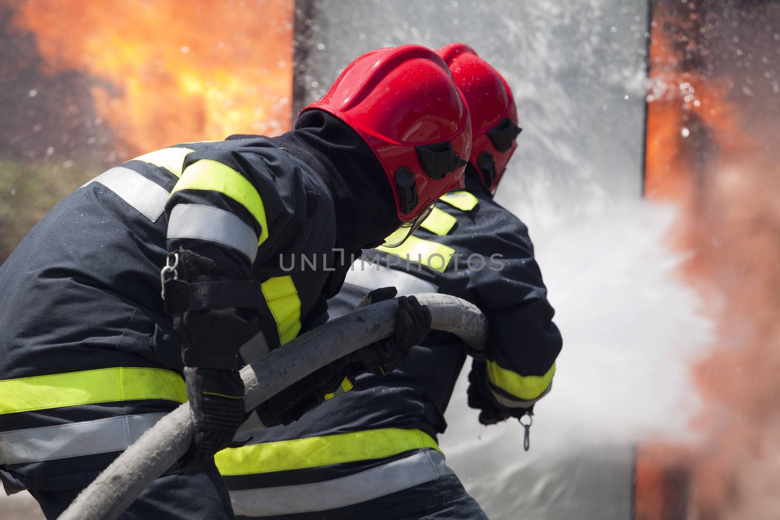 Firefighters fighting fire during training