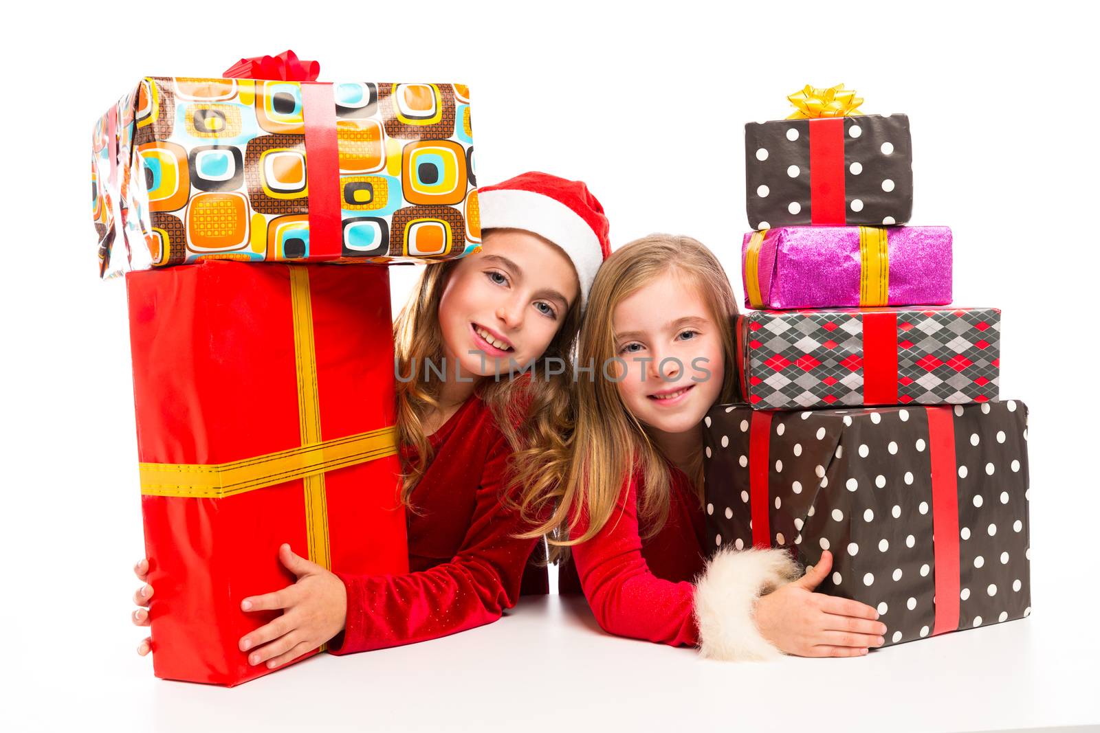 Christmas Santa kid girls with many gifts stacked by lunamarina