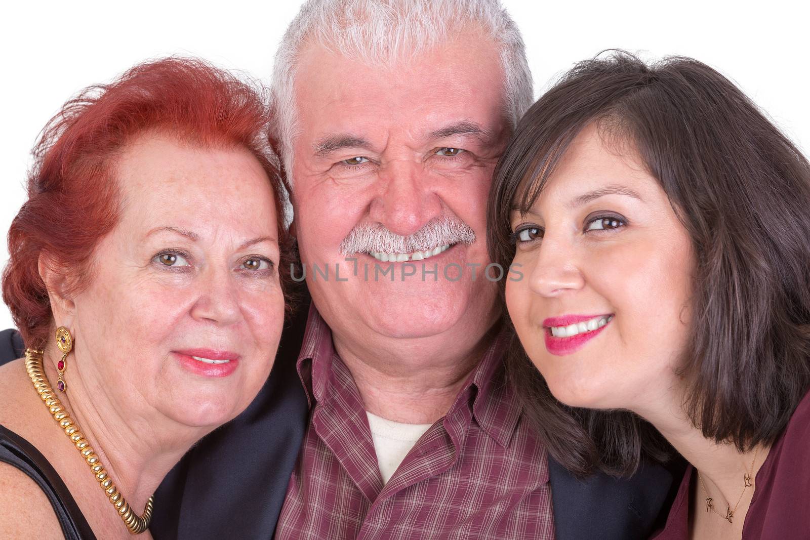 Close portrait of senior couple and their middle age daughter all three of them showing their happiness perhaps its fathers day