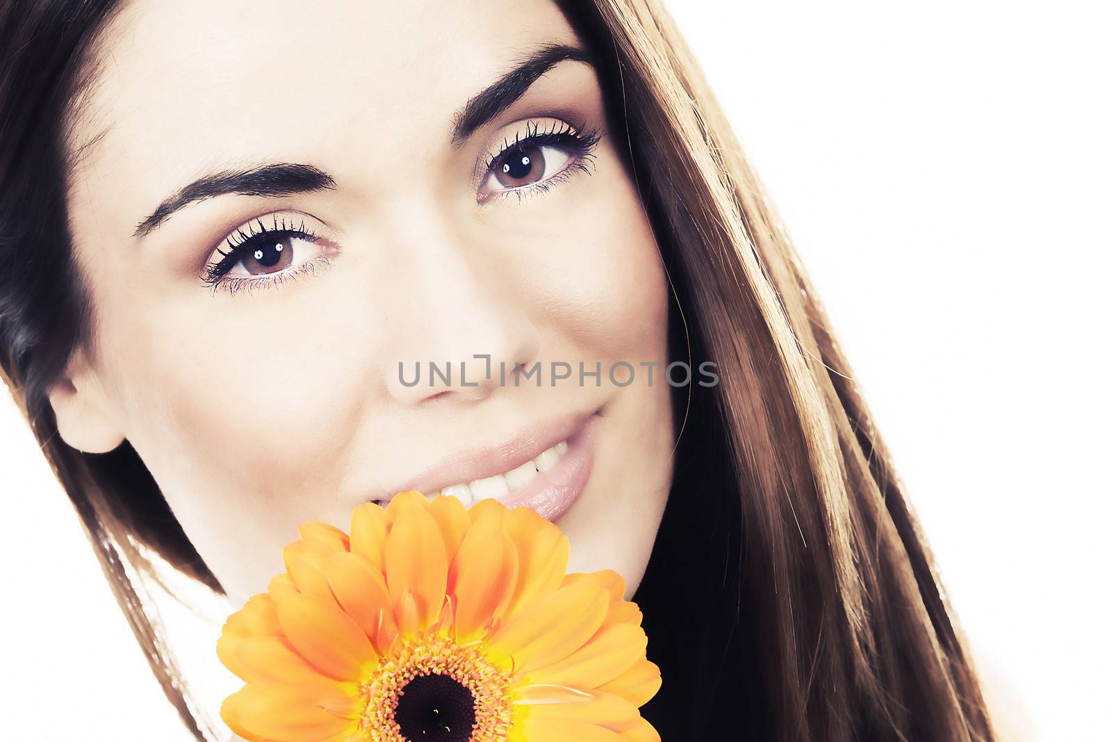 Beautiful woman portrait with flower in studio
