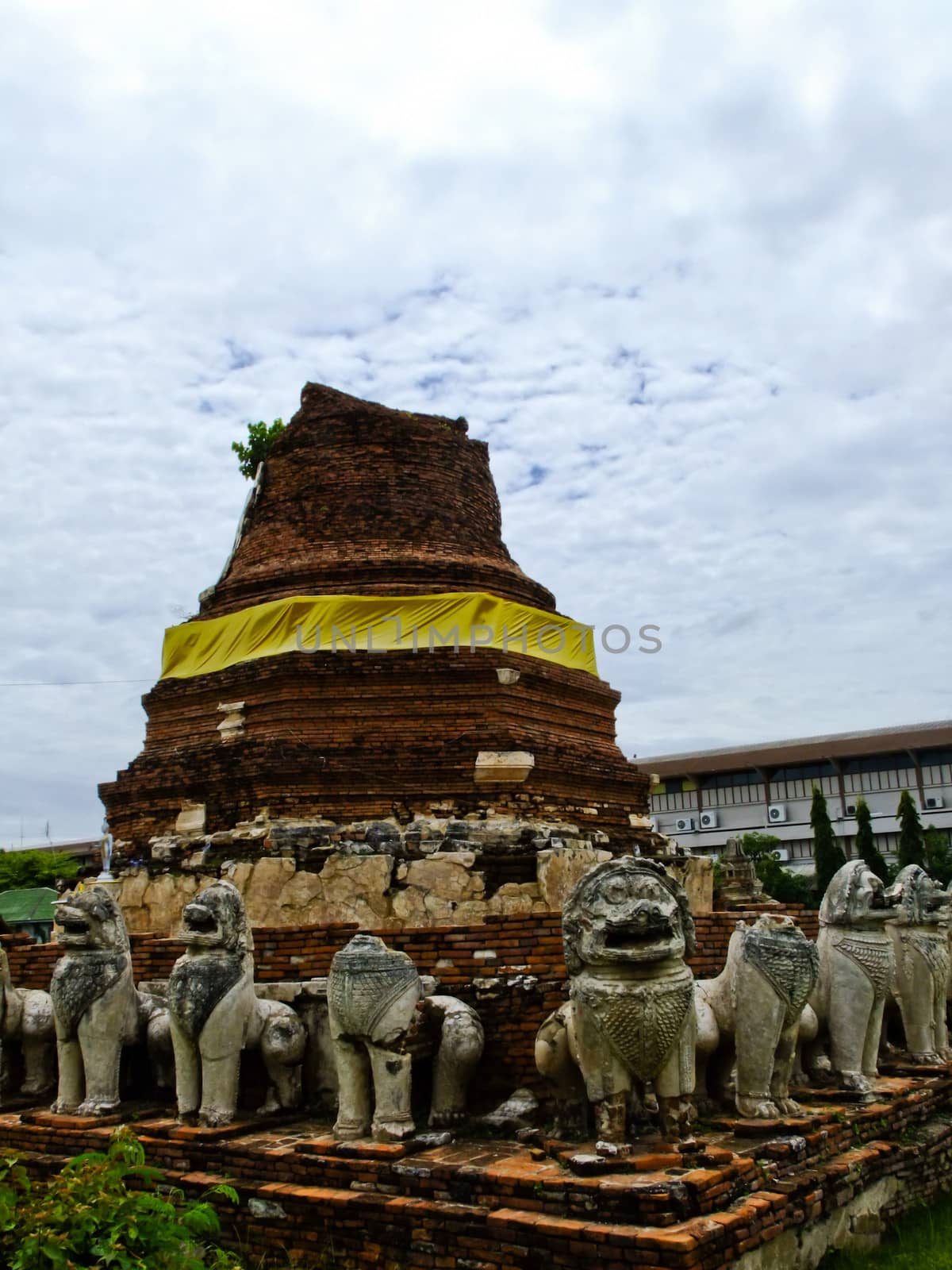 An ancient buddhist pagoda with elephant stone statues in Ayutthaya in Thailand