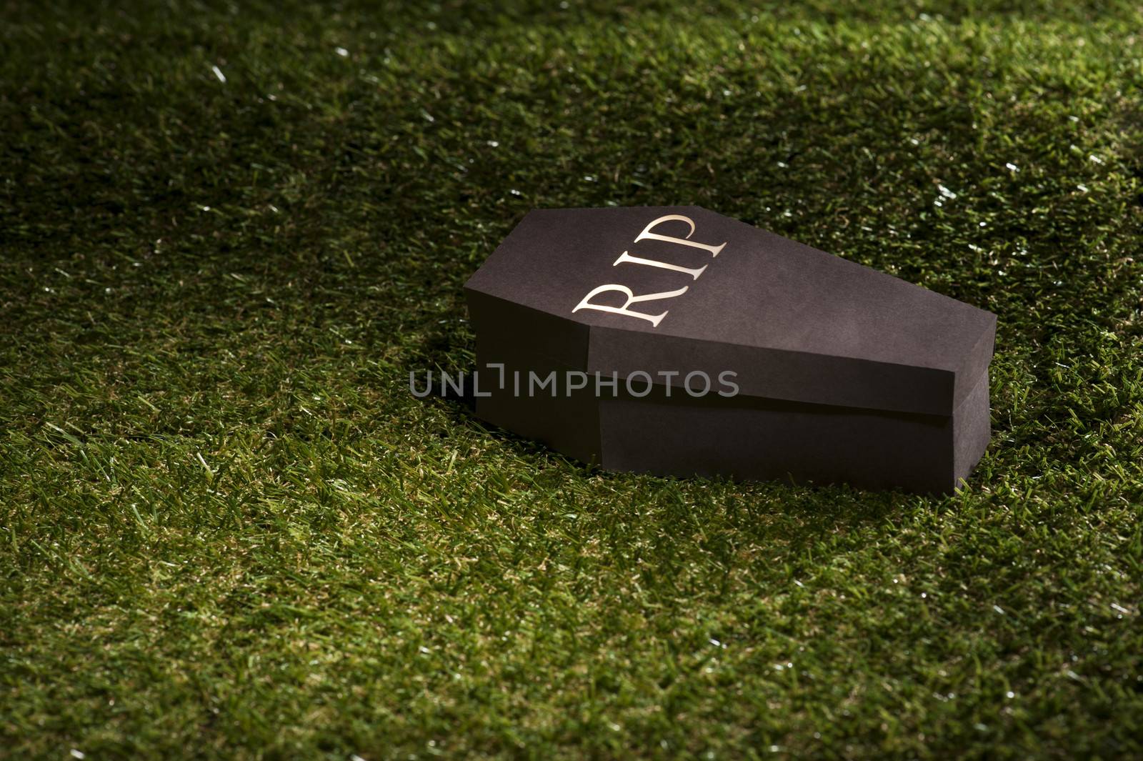 Halloween coffin on lawn with letters RIP