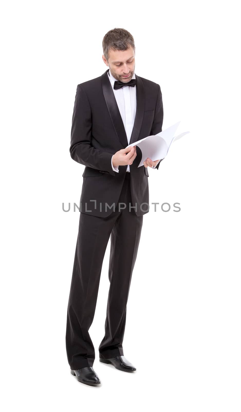 Man in a tuxedo reading the document by Discovod