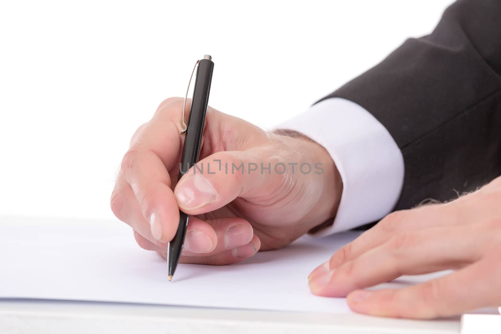 Closeup of the hands of a businessman taking notes holding a pen over a blank sheet of paper as he prepares to begin writing