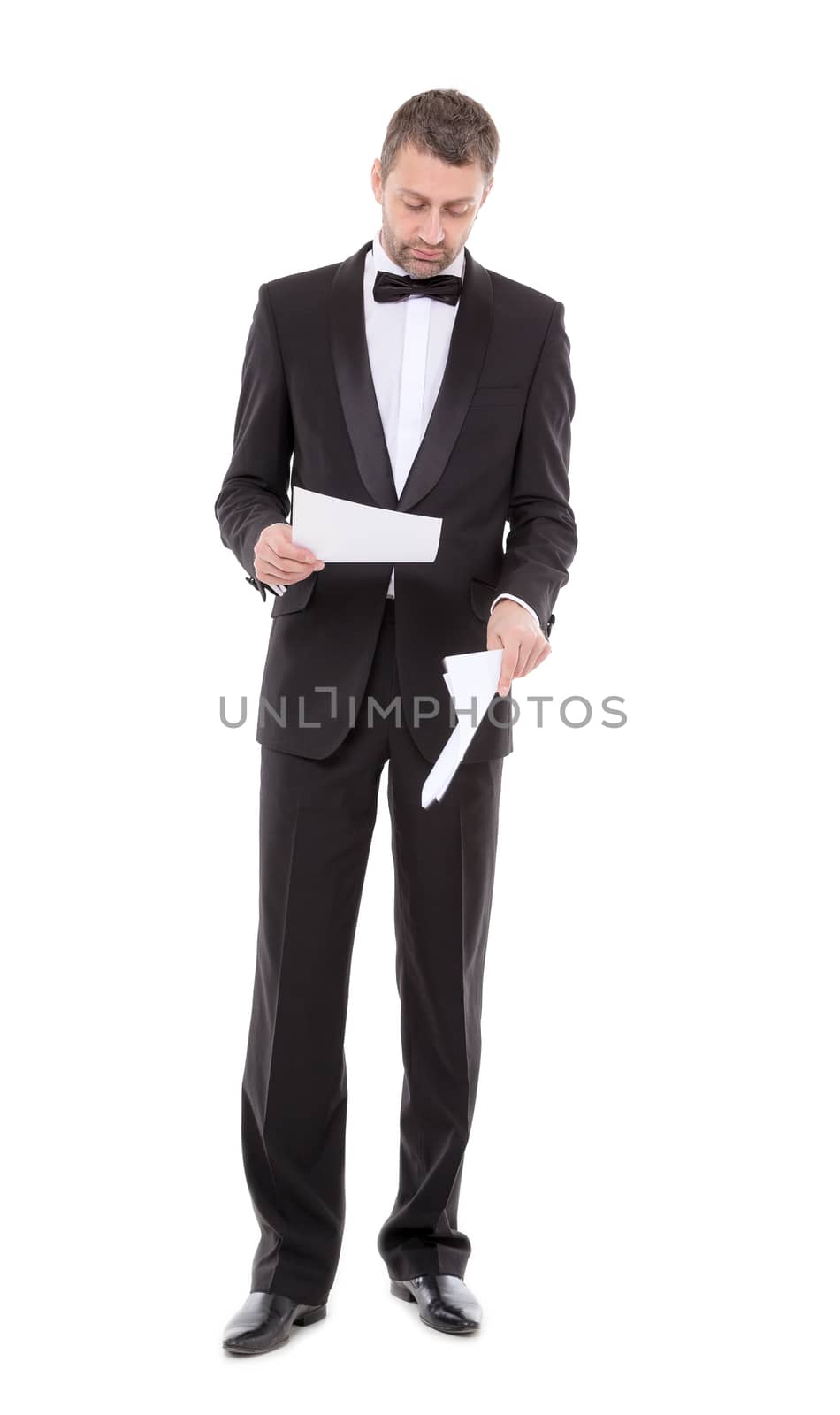 Man in a tuxedo reading the document by Discovod