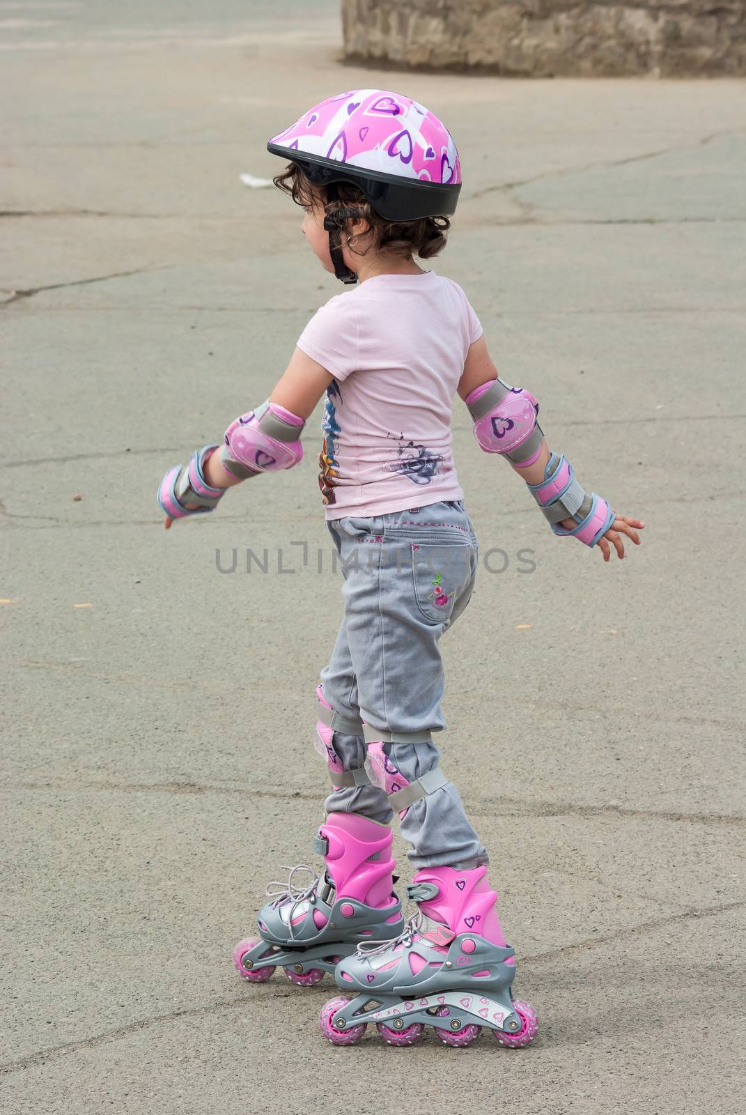 The child in the open air on roller skates