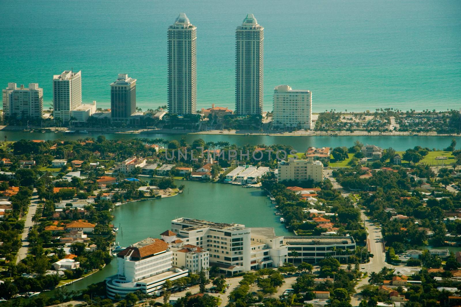 Aerial view of diverse apartment building and skyscrapers in Miami city with waterfront in background, Florida, U.S.A.