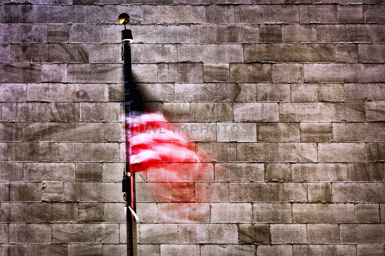 American flag with wall of Washington Monument in background, Washington D.C, U.S.A.