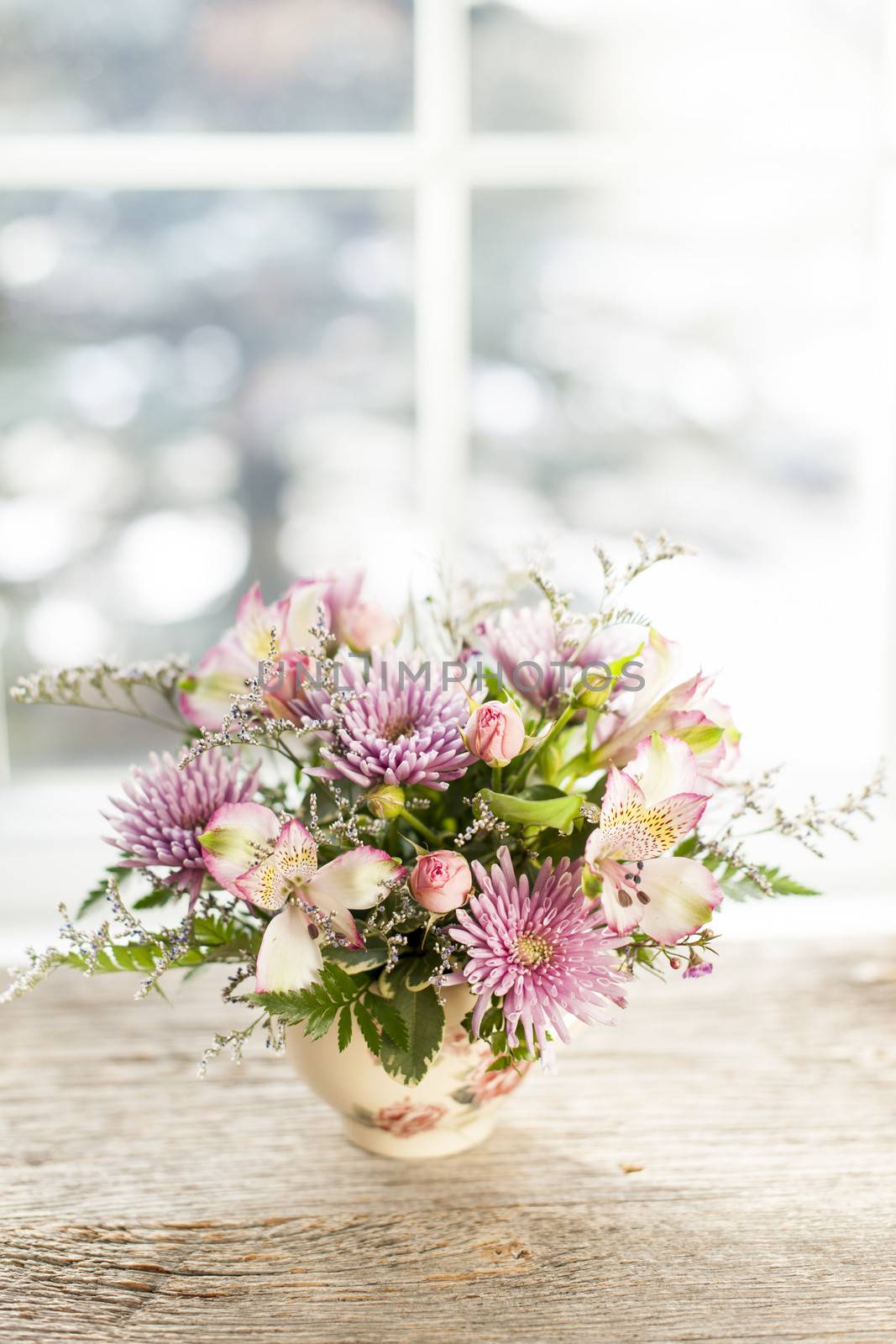 Bouquet of colorful flowers arranged in small vase