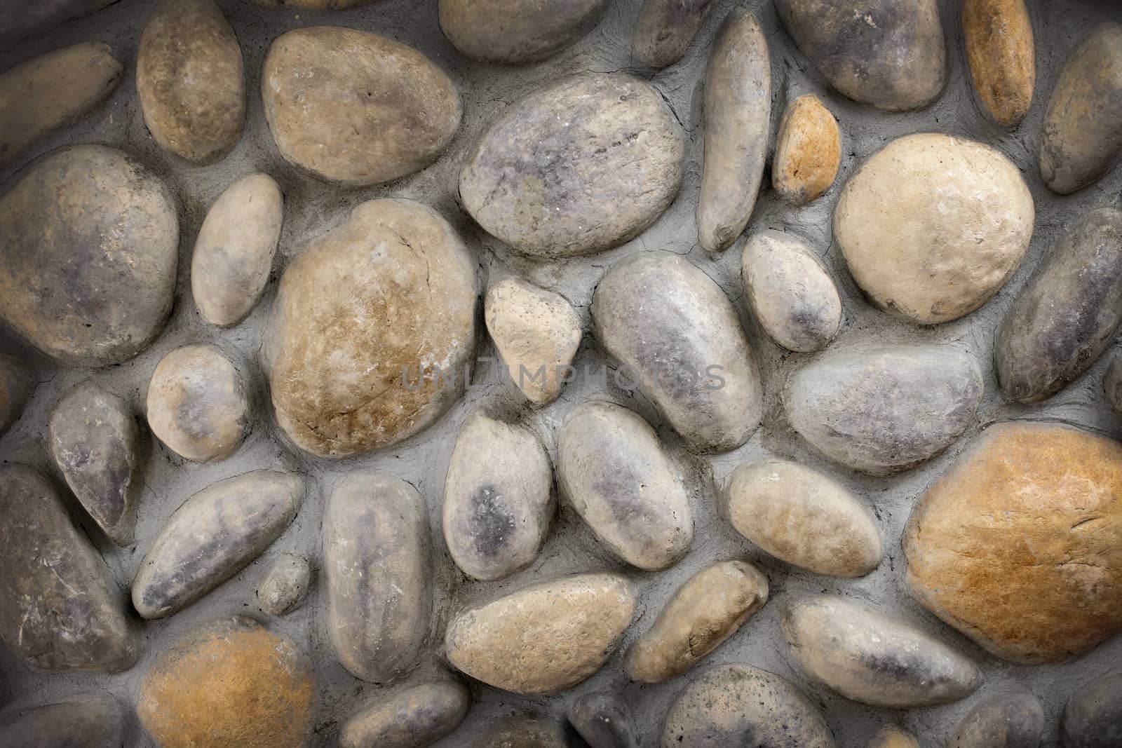 Wall of rocks and stones in cement background