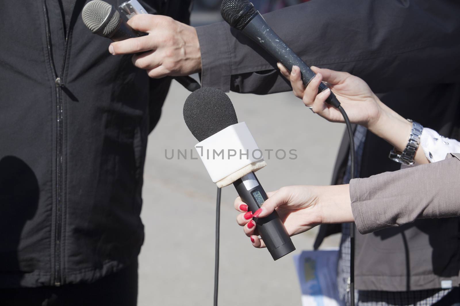 A journalist is making a interview with a microphone