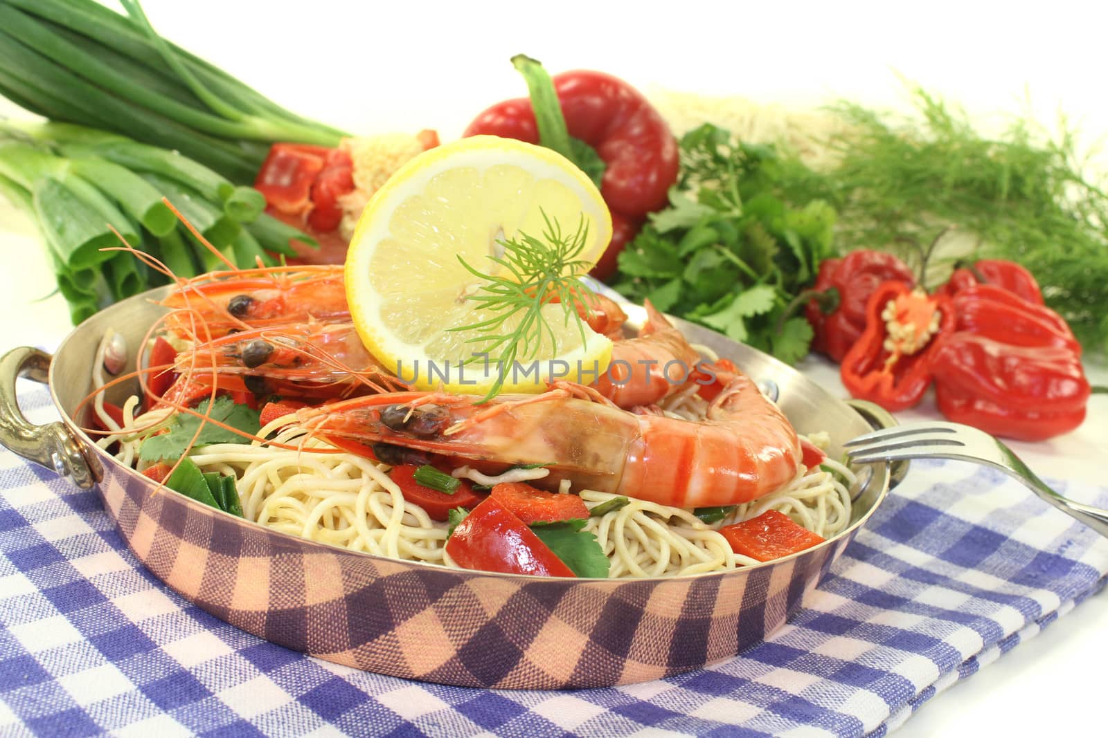Prawns with Mie noodles, lemon, dill and coriander on a light background